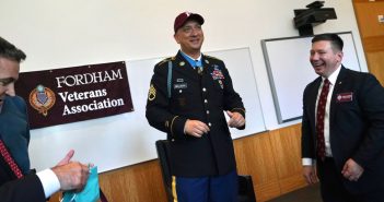 A man wearing a military uniform and a Fordham baseball cap