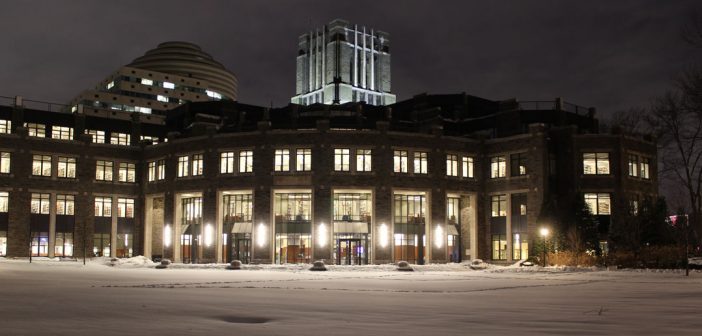 Walsh Library lit up on snowy night