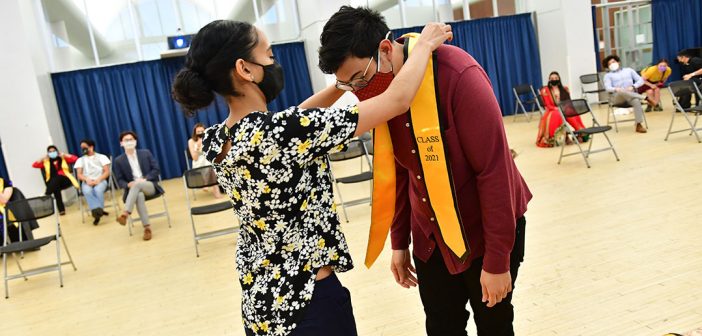 Student receiving yellow stole at AAPI graduation celebration
