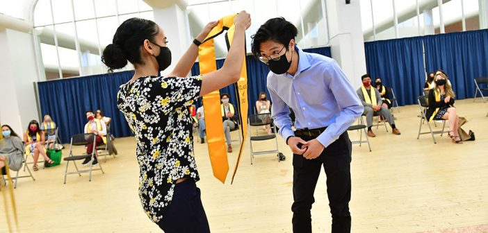 Student receiving yellow stole at AAPI graduation celebration