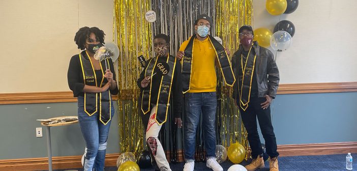Students posing with balloons at Black graduation celebration