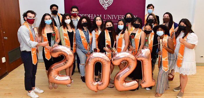 Graduate rewith orange stoles at Latinx graduation