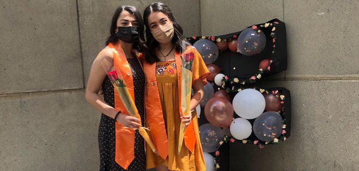 Graduates with orange stoles and balloons at Latinx Graduation