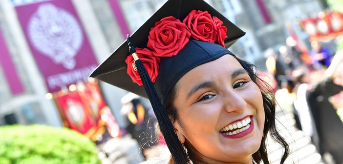 close up of a woman graduate with flowers on her cap
