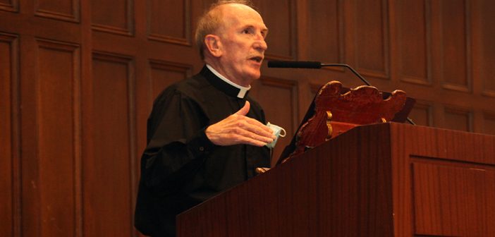 Father McShane delievers the 2021 State of the University address at a wood podium