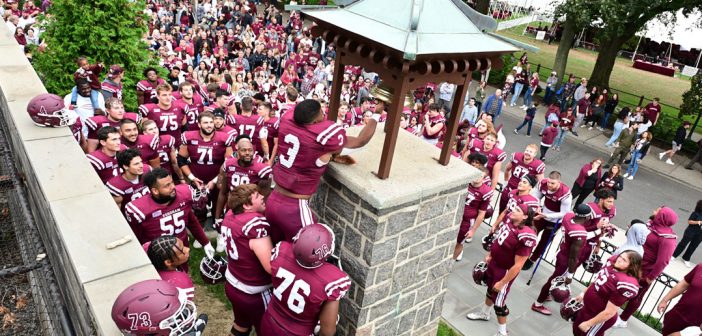Fordham football players ring the victory bell