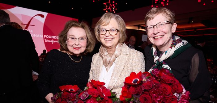 Three women holding flowers