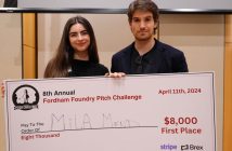 Two people hold a check